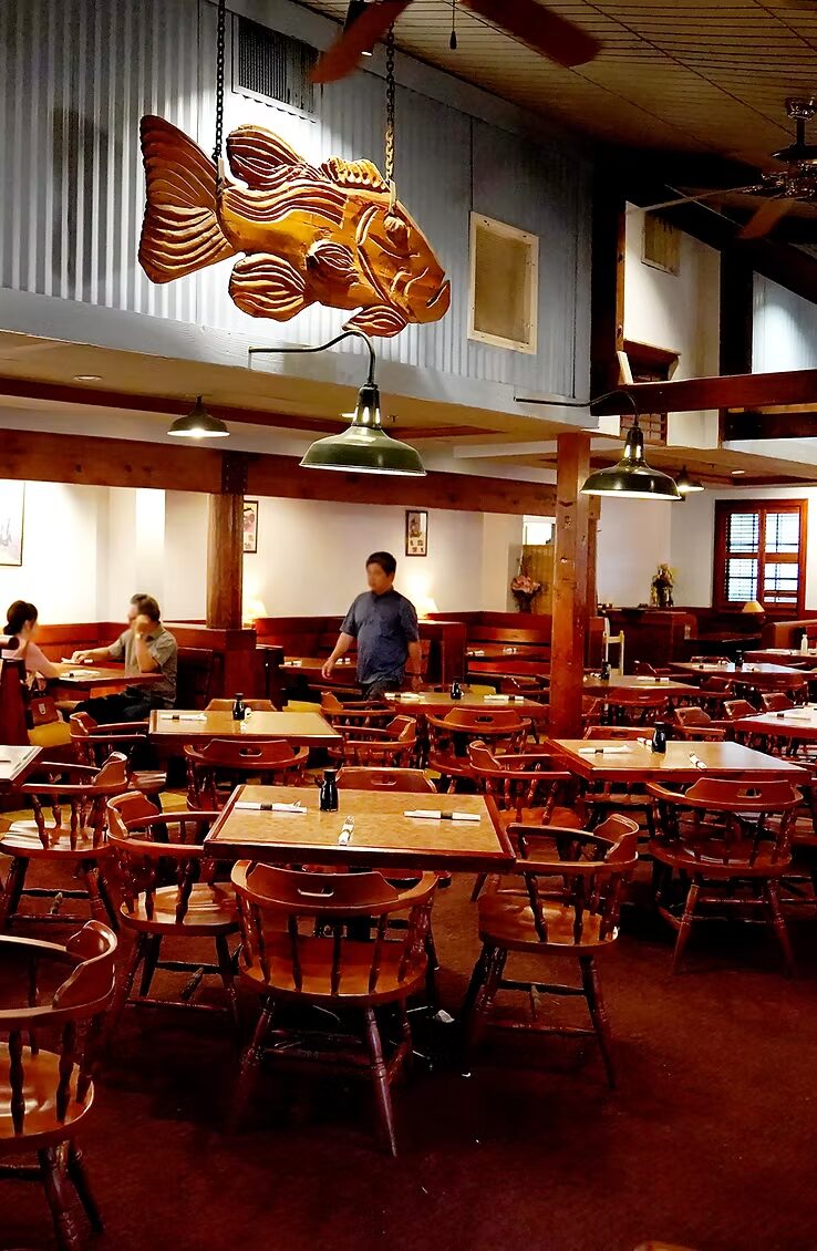 Warm wood dining room with carved fish sculpture