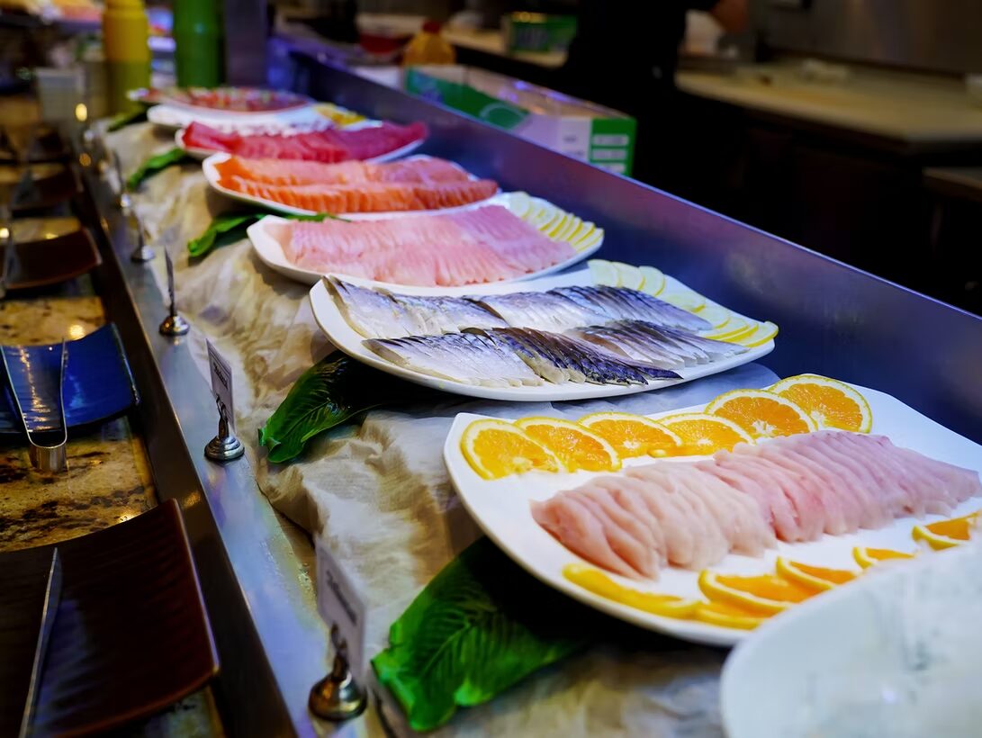 Platters of tuna, salmon and yellowtail sashimi on the chilled line