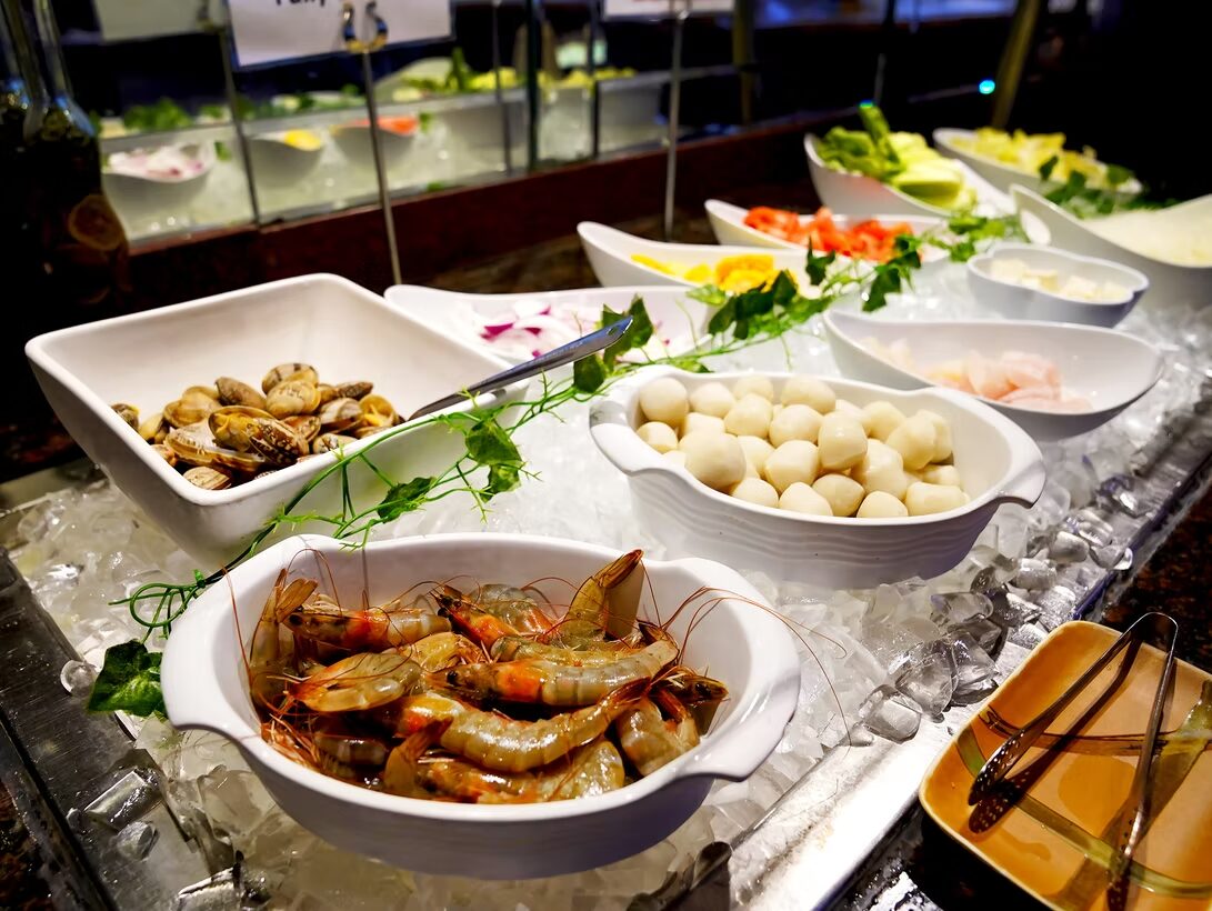 Chilled seafood bar with shrimp, clams and scallops on ice